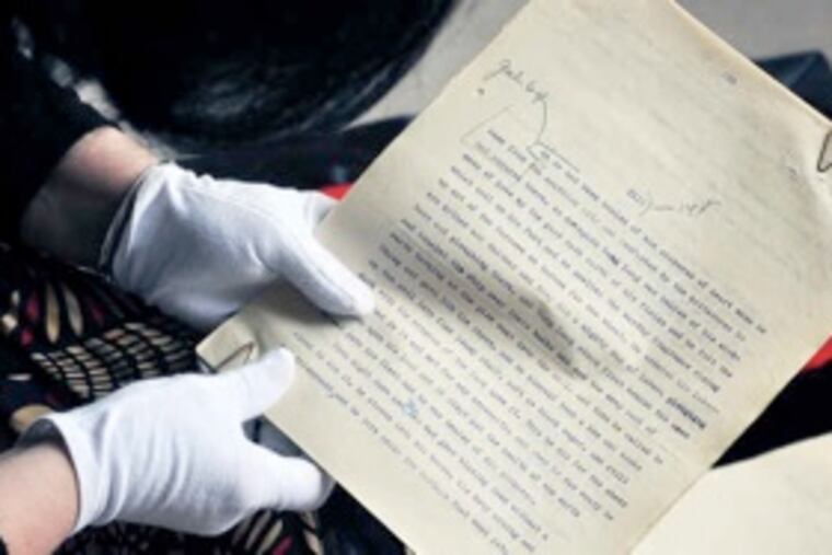 With gloved hands, curator Donna Rhodes holds the 400-page manuscript at the Perkasie offices of Pearl S. Buck International, where it is to be displayed. (Sharon Gekoski-Kimmel / Staff Photographer)