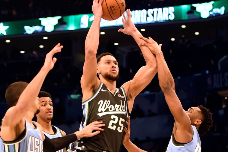 The World Team's, Ben Simmons, of the Philadelphia 76ers, drives between the U.S. Team's Jayson Tatum, of the Boston Celtics, John Collins, of the Atlanta Hawks, and Donovan Mitchell, of the Utah Jazz, during the MTN DEW ICE Rising Stars game at Spectrum Center in Charlotte, N.C., on Friday, Feb. 15, 2019. (David T. Foster III/Charlotte Observer/TNS)