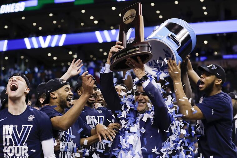 Villanova Head Coach Jay Wright gets the confetti shower holding the East Regional Championship trophy after beating Texas Tech on Sunday at the TD Garden in Boston. Villanova advances to the Final Four.