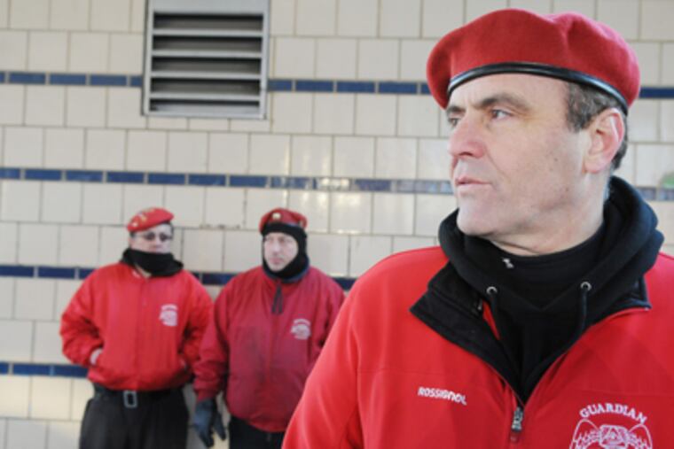 The Guardian Angels' Curtis Sliwa patrols at the corner of Kensington and Somerset streets. The Angels are passing out flyers with a photo of an alleged killer on the loose. (Sarah J. Glover / Staff Photographer)
