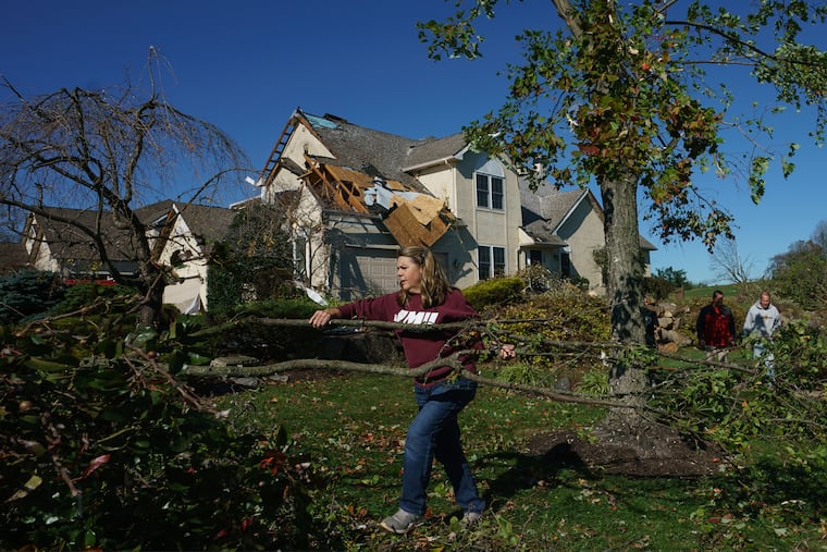 Cindy Bevilacqua moves branches in Thornbury Township, Chester County, after an EF-2 tornado struck in the fall of 2019. No tornadoes have been sighted around here this year, and April was benign nationwide.
