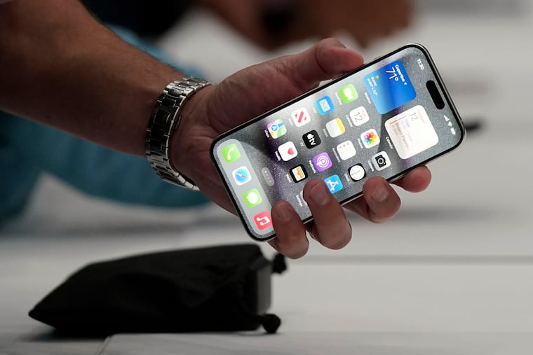 A person holds an iPhone 15 Pro at the Apple campus in Cupertino, Calif., on Sept. 12, 2023.