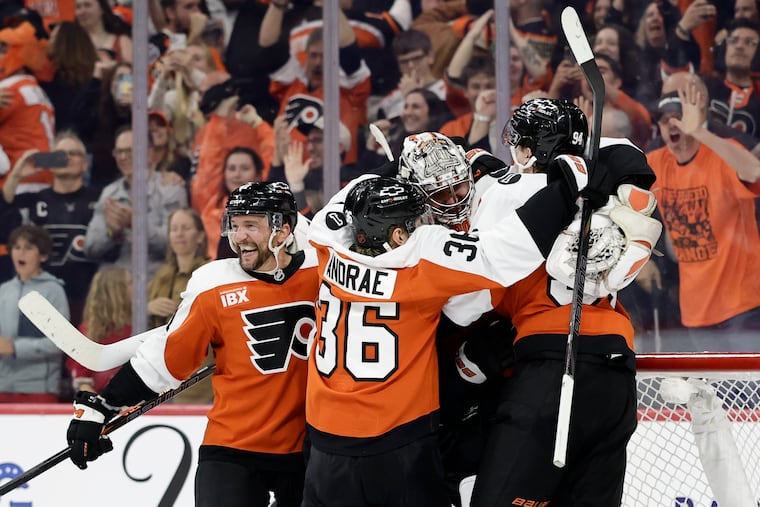 Flyers goaltender Dan Vladar (center) celebrates with his teammates after the Flyers beat the Carolina Hurricanes in a shootout on Monday.