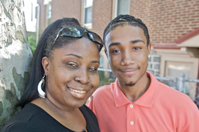 Amir Blount-Hart, with his mother Wendy Blount near their west Philadelphia homer. Amir is graduating with a perfect attendance record.