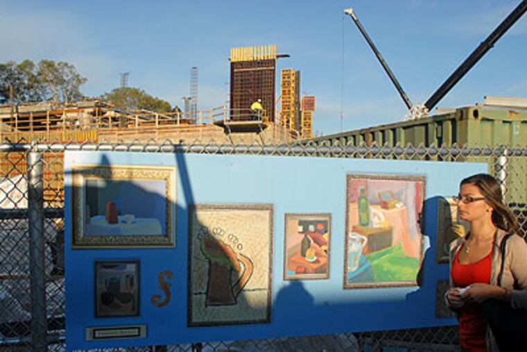 Art by students from Friends Select School, created in the style of the artists whose works are part of the Barnes' collection, adorn the construction fence along 20th Street on Friday as work continues on the collection's new home. (Tom Gralish / Staff Photographer)