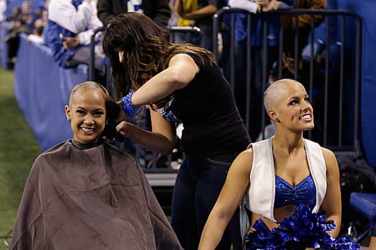 Indianapolis Colts cheerleader Crystal Ann (left) and Megan M. (no last name) have their heads shaved by the Blue the Colts mascot during the second half of an NFL football game between the Indianapolis Colts and the Buffalo Bills in Indianapolis, Sunday, Nov. 25, 2012. Money was raised for leukemia research in honor of head coach Chuck Pagano. (Darron Cummings/AP)