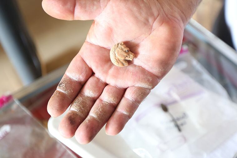Michael Manerchia holds a clay button. The Marcus Hook Plank House dates back to the 1700s, and is constructed with materials harvested from an old ship. They hope to raise $7,000 to finish up an artifact library to house the items and create a space for college students and archeologists to work and study what has been uncovered. ( DAVID SWANSON / Staff Photographer )
