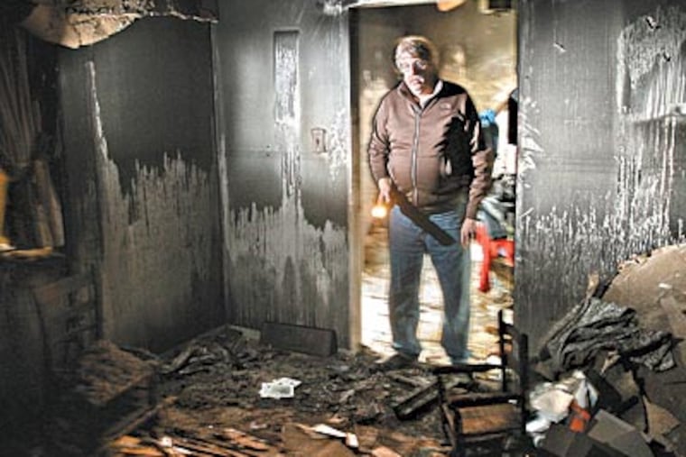 Jim Reilly returns to his burned-out Boothwyn house, where he sometimes looks for old treasures amid the rubble. Besides losing his home to fire, he has lost his wife, a son, and his job. (MICHAEL BRYANT / Staff Photographer)