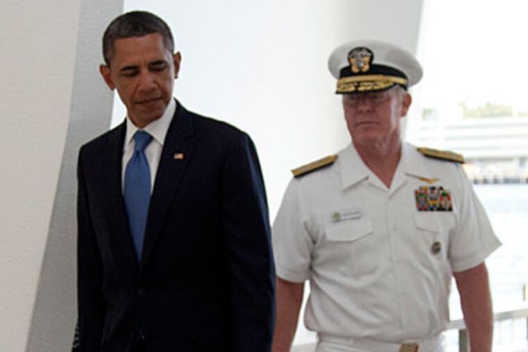 President Barack Obama, left, and Admiral Robert Willard, arrive to participate in a wreath laying ceremony at the USS Arizona Memorial, part of the World War II Valor in the Pacific National Monument, Thursday, Dec. 29, 2011, in Pearl Honolulu, Hawaii. (AP Photo/Carolyn Kaster)