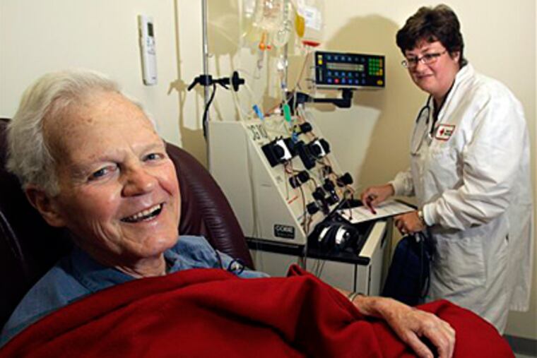 In this Aug. 16, 2010 photo, patient Bob Svensson is hooked up to a blood infusion machine under the care of Nancy Grant, a registered nurse at the American Red Cross in Dedham, Mass., as he undergoes a $93,000 prostate cancer treatment. The Provenge therapy adds four months' survival, on average, for men with incurable prostate tumors. (Elise Amendola/AP/File)