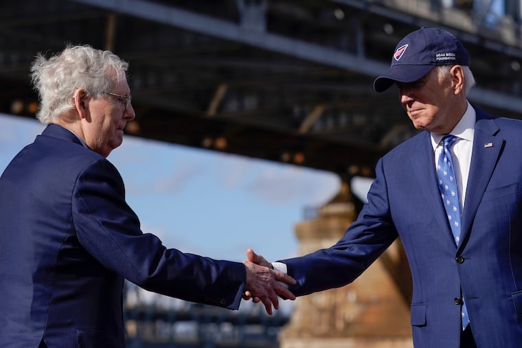 President Joe Biden shakes hands with Senate Minority Leader Mitch McConnell of Ky., after speaking about his infrastructure agenda under the Clay Wade Bailey Bridge, Wednesday, Jan. 4, 2023, in Covington, Ky. (AP Photo/Patrick Semansky)