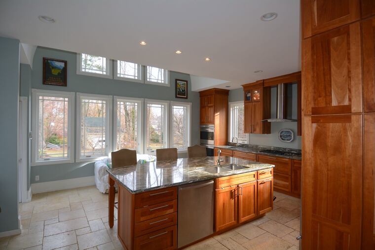 The dark, dated original kitchen in the 1888 Queen Anne/Stick Style house was a nonstarter for the new owners. So they added a large addition with a 21st-century interior that matched the house's exterior.
