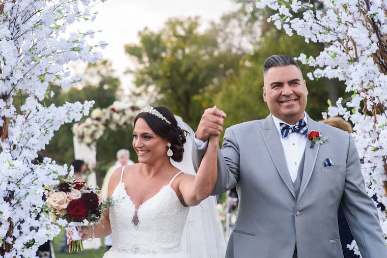 Stacie Steinbrecher and her new husband, Bruno Marcinkowski walk down the aisle after they said "I do" at The Union League Golf club at Torresdale on 10/12/19.