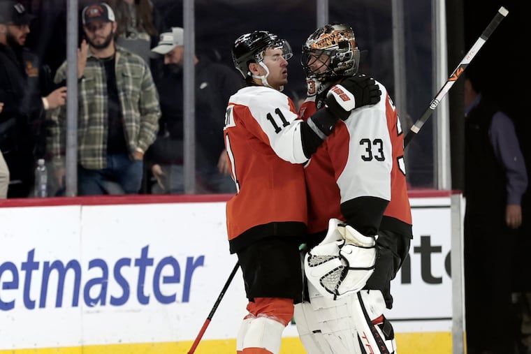 Flyers' Travis Konecny (11) and goalie Sam Ersson celebrate after Tuesday's win over the Penguins. Konecny scored his 200th career goal in the contest.