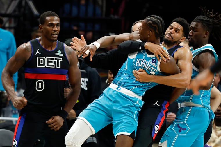 Charlotte Hornets forward Moussa Diabate is held back as he fights with Detroit Pistons center Jalen Duren (0) on Monday.