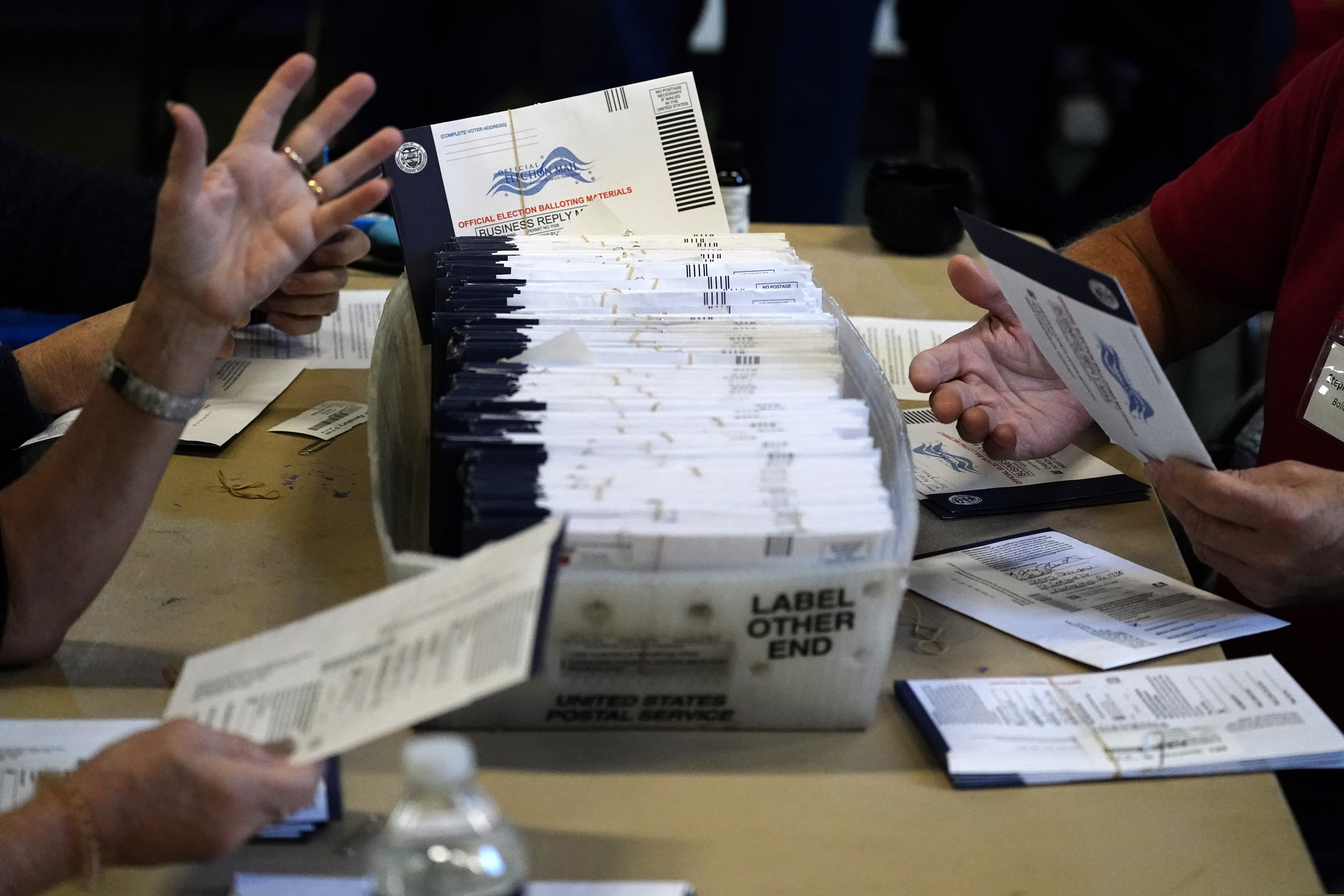 Chester County election workers process mail-in and absentee ballots for the 2020 general election in the United States at West Chester University in West Chester, Pa.