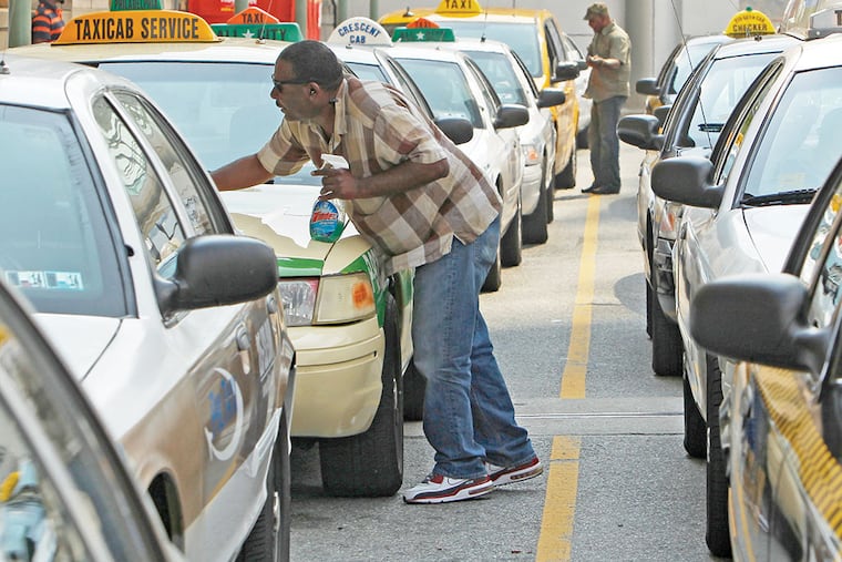 Cabdrivers, such as these at 30th Street Station, may face an uncertain future with regard to their insurance as the PUC investigates a major carrier. (RON CORTES/File Photo)