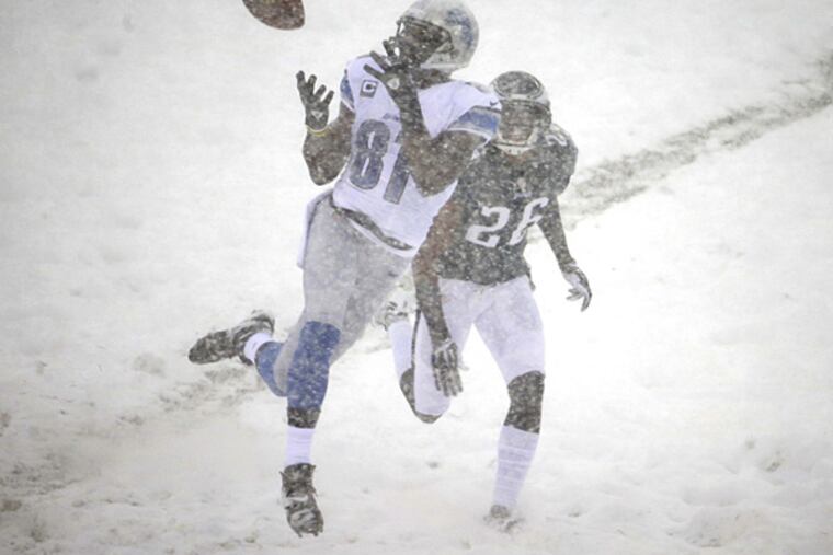 Lions wide receiver Calvin Johnson catches a pass as Eagles cornerback Cary Williams defends during the first half. (Matt Rourke/AP)