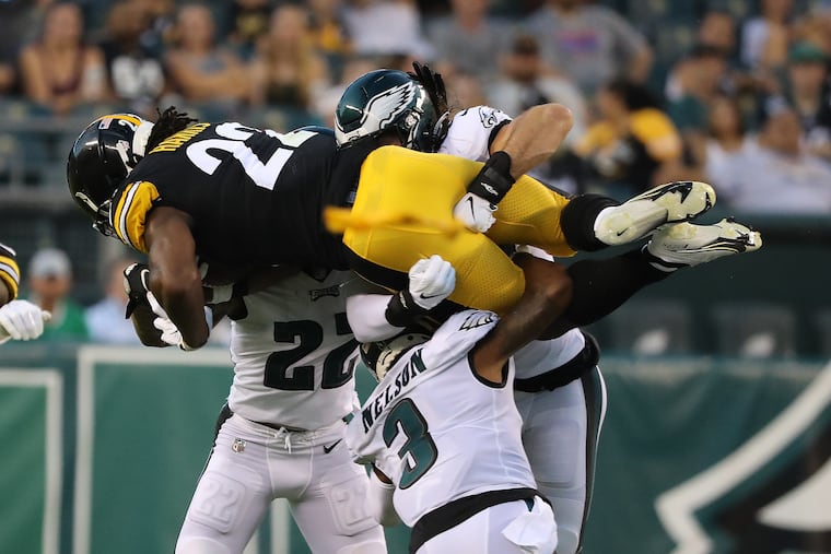 Eagles (left to right) Marcus Epps, Steven Nelson, and Alex Singleton tackled Steelers running back Najee Harris during their preseason game on Aug. 12.