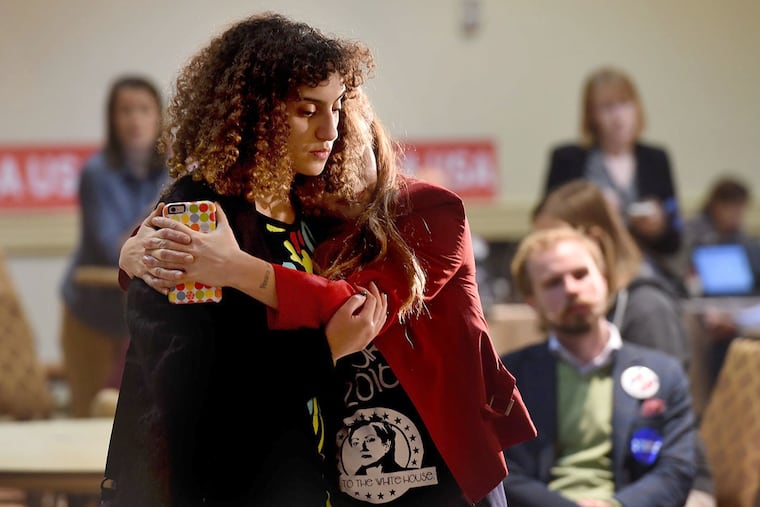 Rana Fayez (left) and Lisa Powell Graham (right) hold each other as they watch voter returns at the election night party for Senate candidate Katie McGinty in the early morning November 9, 2016. TOM GRALISH / Staff Photographer