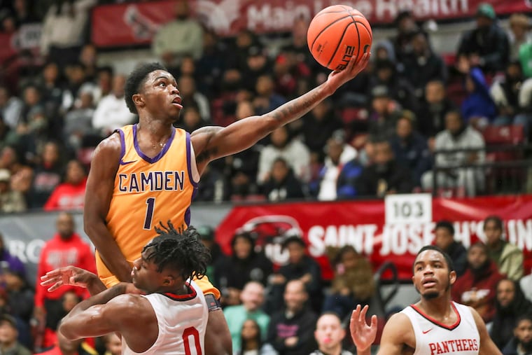 Camden’s Cian Medley goes up for a shot over Imhotep’s Ahmad Nowell in the first half of a game at Hagan Arena in January. Camden won, 60-57.