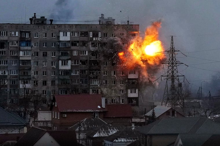 An explosion erupts from an apartment building after a Russian army tank fired on it in Mariupol, Ukraine, in 2022. The image is part of the documentary "20 Days in Mariupol."