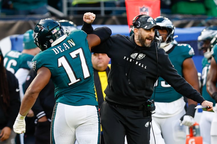 Eagles coach Nick Sirianni celebrates with linebacker Nakobe Dean after the team's game-clinching defensive stand.