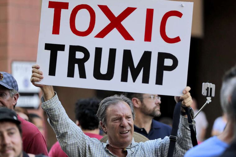 An anti-Trump protester outside the Phoenix Convention Center earlier this month.