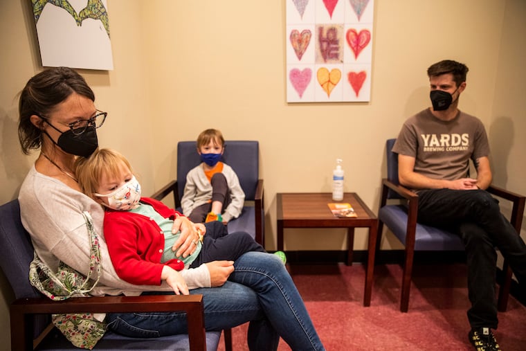 Tonya Walker and Tyler Johnson wait for their children to receive their COVID vaccines at Lankenau Medical Center in June.