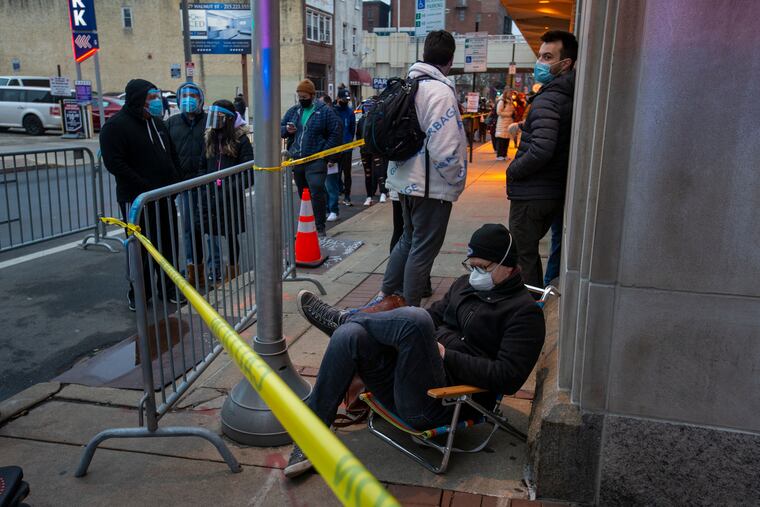 A Philadelphia resident waits early Wednesday morning for a walk-in vaccine at the FEMA-run mass vaccination clinic at the Pennsylvania Convention Center.