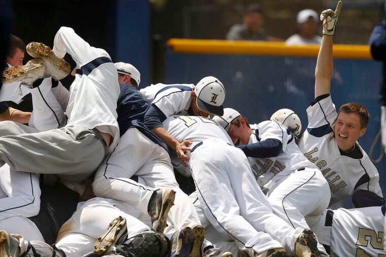 RON CORTES / STAFF PHOTOGRAPHER La Salle teammates celebrate their Catholic League title Saturday at Widener.