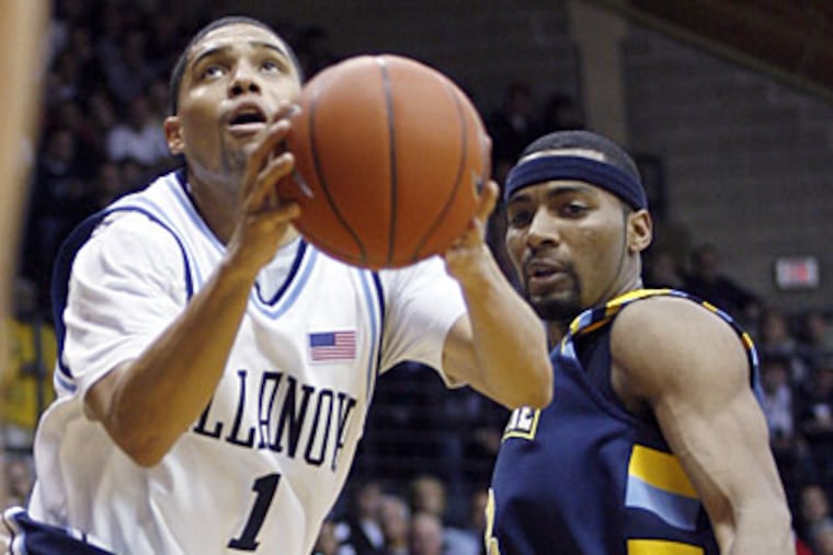Marquette's Lazar Hayward defends as Scottie Reynolds (1) goes up for a shot in the second half. (AP Photo/H. Rumph Jr)