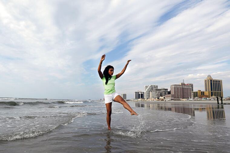 Miss America 2014 Nina Davuluri kicks water during the traditional dipping of the toes in the Atlantic Ocean the morning after being crowned Miss America, Monday, Sept. 16, 2013, in Atlantic City, N.J. Davuluri represented New York. (AP Photo/Julio Cortez)