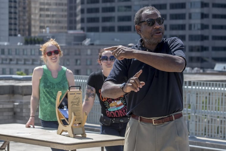 Franklin Institute chief astronomer Derrick Pitts leads an eclipse workshop on the roof of the institute.