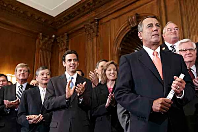 Speaker of the House John Boehner, R-Ohio, right, is cheered as Republican members of the House of Representatives rally after passing a bill that would prevent a government shutdown while crippling the health care law that was the signature accomplishment of President Barack Obama's first term, at the Capitol in Washington, Friday, Sept. 20, 2013. The top Senate Democrat, Sen. Harry Reid, D-Nev., has pronounced the bill dead on arrival and calls the House exercise a "waste of time." Applauding at left in front is Rep. Tom Graves, R-Ga., who led conservatives in persuading Boehner to accept a deal to link defunding the Affordable Care Act with the continuing resolution for government funding. (AP Photo/J. Scott Applewhite)