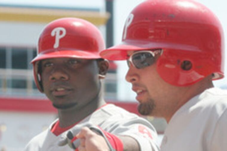 Ryan Howard greets Shane Victorino (right) after he scored on Howard's sacrifice fly in the first. Howard also had a two-run homer. The Phillies won back-to-back games for the first time this season.