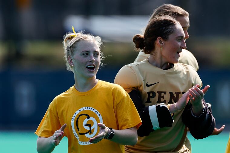 Injured Penn field hockey player Annie Bartosz (left) with her teammates before Penn played Northwestern last Friday.