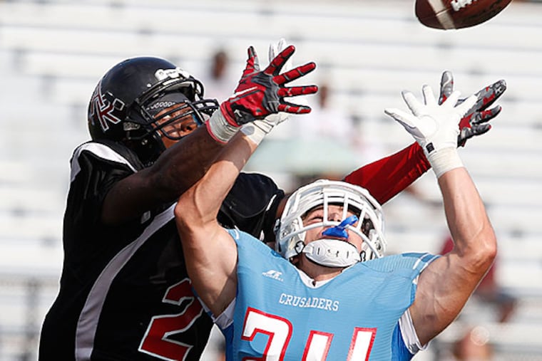 Tom Penko, right of Father Judge goes up in front of Jeremy Smith of Archbishop Ryan to intercept a pass in the end zone during the 4th quarter. Father Judge defeated Archbishop Ryan 20-14 at Northeast High School on Sept. 4, 2015.