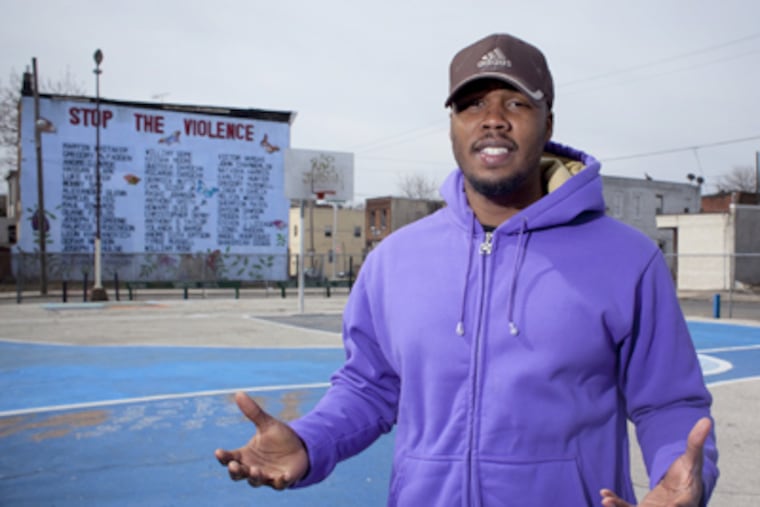 Omar Singletary, a student mentor and life coach, stands on the playground at 20th and Tasker and ponders the future of his community. (Ed Hille / Staff Photographer)