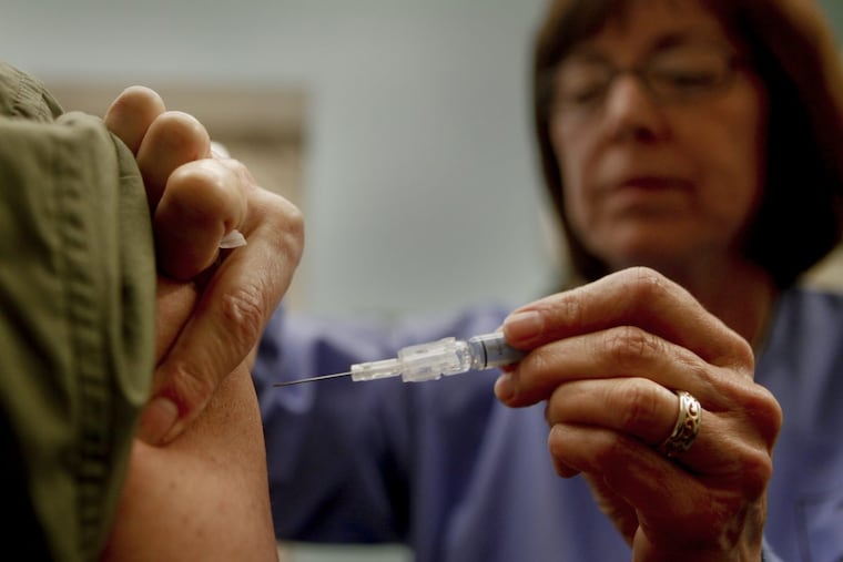 Downey Regional Medical Center RN Connie Meinke administers the flu vaccine to fellow employee Brian Virk on January 17, 2013.