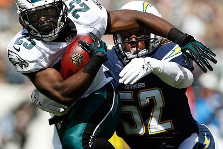 Eagles' LeSean McCoy, left, is chased down by the Chargers' Reggie
Walker, right, during the first quarter. (David Maialetti/Staff Photographer)