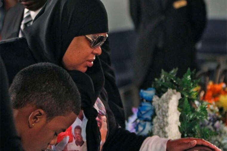 At funeral services after the March 2012 slayings of Dexter Bowie and Jonathan Stokley, Bowie’s mother pays her respects.