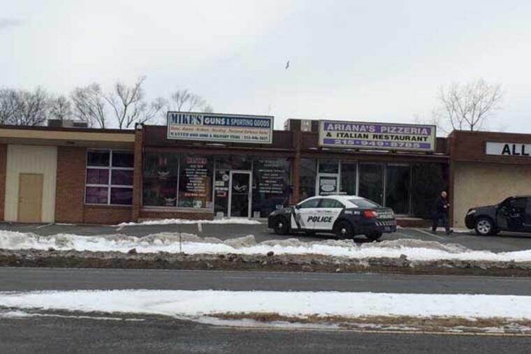 A police car sits in front of the gun store where a standoff that began with a burglary occurred on Feb. 23, 2015. (Chris Palmer / staff)