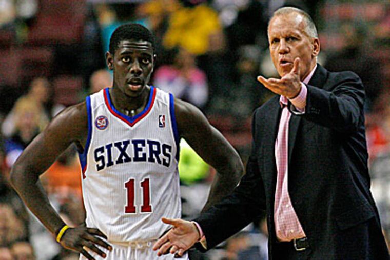 Sixers guard Jrue Holiday with head coach Doug Collins. (H. Rumph Jr/AP)