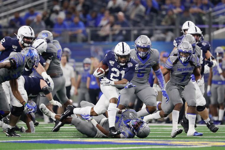 Penn State running back Noah Cain running over Memphis linebacker Xavier Cullens during the Cotton Bowl on Dec. 28.