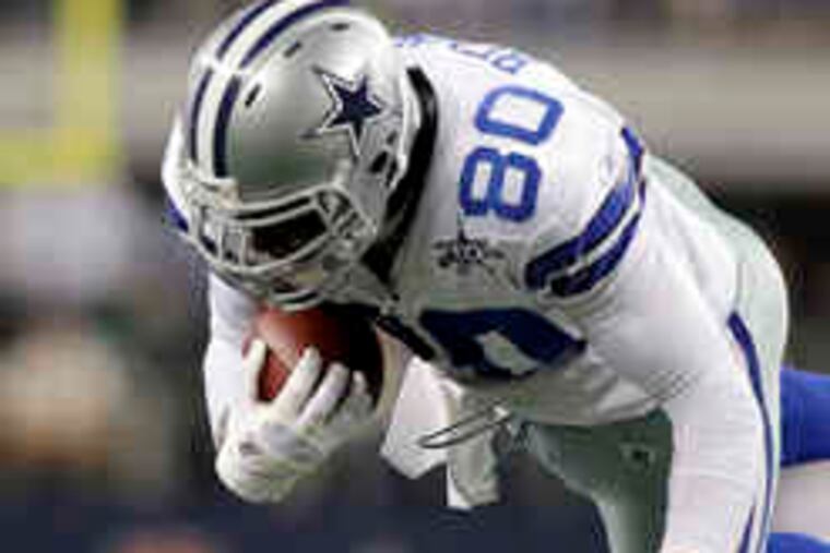 Cowboys tight end Martellus Bennett is upended by Giants cornerback Corey Webster in the first half in Arlington, Texas. The game ended too late for this edition.