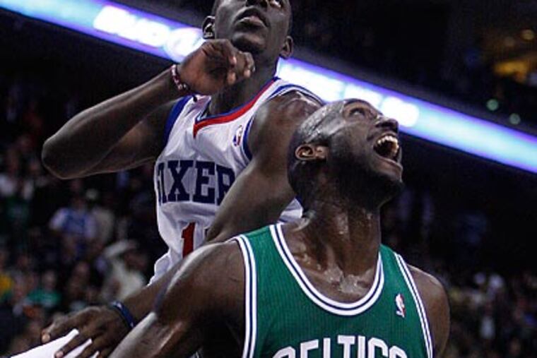 Jrue Holiday watches Kevin Garnett's game-winning layup in Thursday's late loss to the Celtics. (Ron Cortes/Staff Photographer)