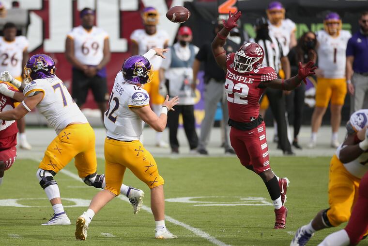 East Carolina quarterback Holton Ahlers tries to throw the ball past Temple linebacker Kobe Wilson on Saturday.