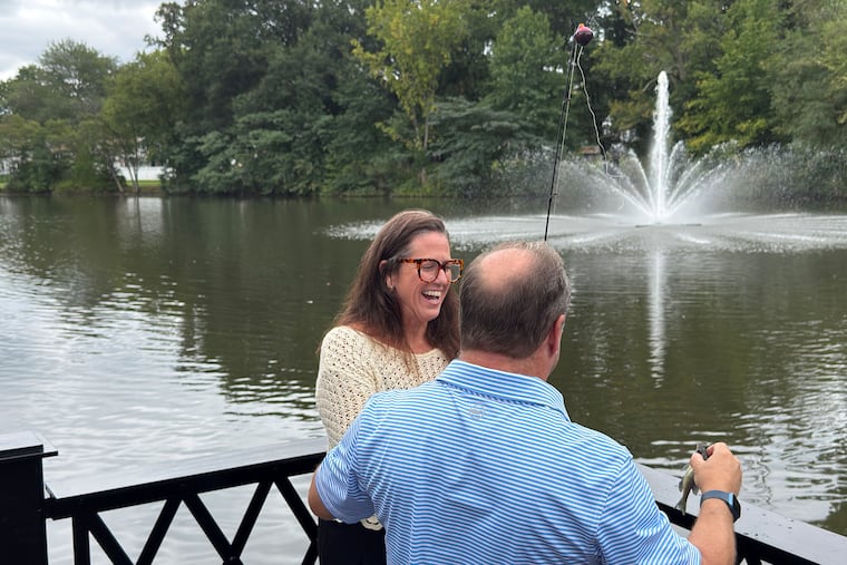 Camden County Commissioner Director Louis Cappelli Jr. prepares to toss Oaklyn Borough Council president Nancy MacGregor's catch back into the lake.