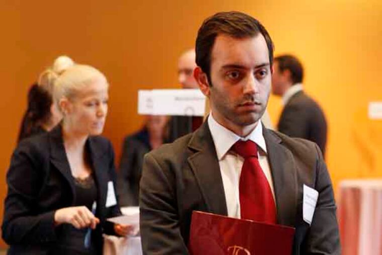 Senior Shehryar Mazhar, 23, waits to talk with an employer.The Career and and Intern Fair at Philadelphia University. February 14, 2013. ( MICHAEL S. WIRTZ / Staff Photographer ).